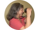 The author, Renee, is looking through binoculars and smiling
